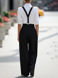 Detail view of adjustable Y-back suspenders and high-waist wide-leg trousers for professional wear