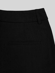Detail view of the waistband and rear pocket on these black high-waisted casual trousers