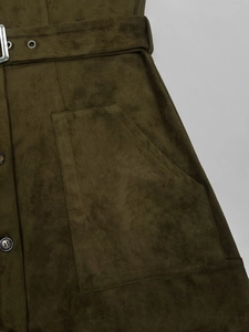 Détail de la robe en daim vert foncé avec boucle de ceinture et grande poche plaquée