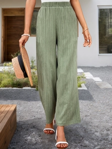 Grass green high waisted wide leg trousers with textured pleats and elastic waistband