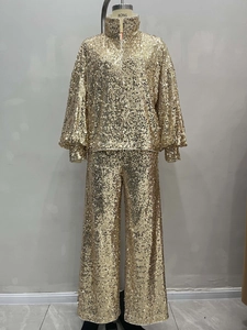 Women's glamorous gold sequin two-piece set featuring a high neck zip jacket and wide-leg pants