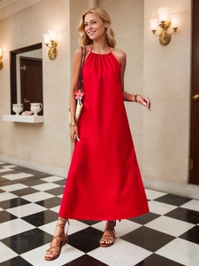 Detail of red satin halter maxi dress showing glossy fabric texture and elegant pleated chest