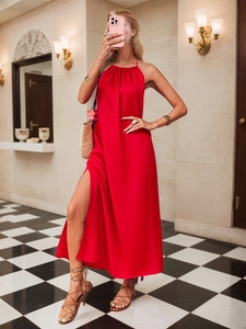 Detail of red satin halter maxi dress with elegant side slit and open shoulder design