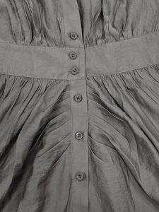 Detail view of charcoal grey shirt dress with pleated texture and button closure