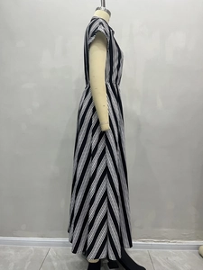 Detailed side view of black and white vertical striped short sleeve maxi dress with belted waist