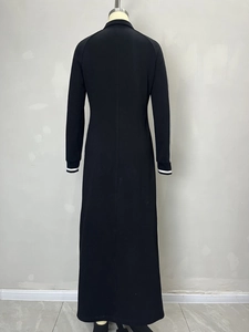 Minimalist black long-sleeve maxi dress with white piping and button collar detail