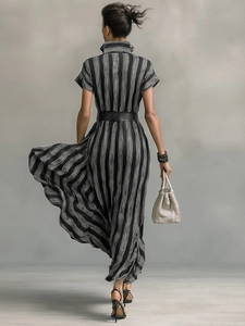 Rear view of an elegant black and white striped shirt maxi dress with a black wide belt