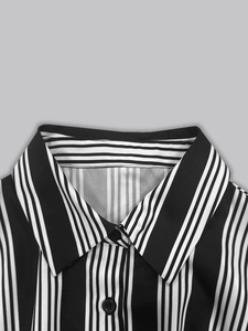 Detailed close-up of the black and white vertical striped shirt collar and buttons