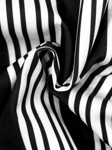 Detailed macro view of black and white vertical stripe fabric texture on shirt dress