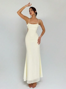 Detail of waist cut-out and sleek satin fabric on a cream mermaid maxi evening dress