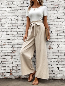 Detail of high waist wide leg pants with adjustable bow tie knot for summer