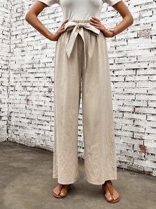 Detail of high waist wide leg pants with adjustable knot tie and elastic paperbag waist
