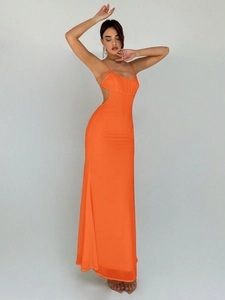 Detail of elegant orange maxi dress showing sexy waist cutouts and thin shoulder straps
