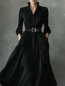 Elegant black pleated shirt dress with long sleeves and matching belt in A-line silhouette