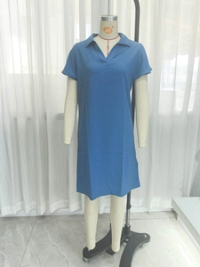 Detail view of the blue polo neck dress with short sleeves and fine crepe texture fabric