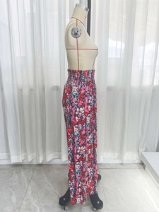 Detail of high waisted smocked elastic waistband on floral print wide leg trousers
