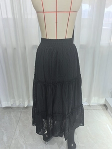 Detail view of black Swiss dot tiered maxi skirt with three layers and elastic waistband