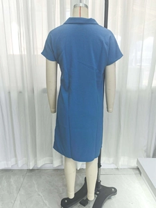 Detailed back view of a navy blue polo dress with textured crepe fabric on a mannequin