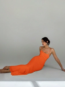 Detail view of orange slim fit maxi evening dress with thin straps and cutout design