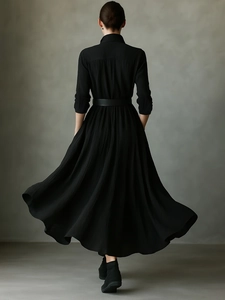 French style black pleated maxi shirt dress with long sleeves and a slim waist belt