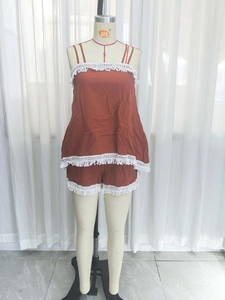 Women's two-piece beach set featuring camisole and shorts with white lace tassel trim