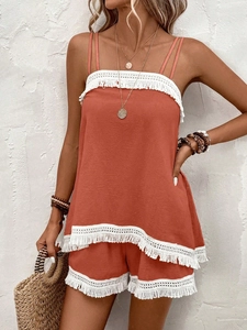 Detail of bohemian terracotta two-piece set with white fringe lace trim on cotton fabric