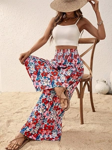 Detail of high waisted smocked elastic waistband on red floral wide leg beach trousers
