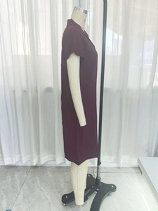 Side view of elegant burgundy short-sleeved polo dress with classic collar on mannequin