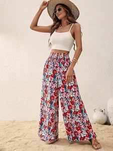 Detail of high waisted floral wide leg pants paired with a white ribbed cropped camisole