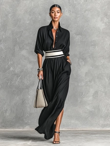 Detail of long sleeve black shirt dress with a striped wide belt and lapel collar
