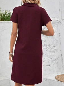 Back view of elegant wine red polo dress with short sleeves and premium textured fabric