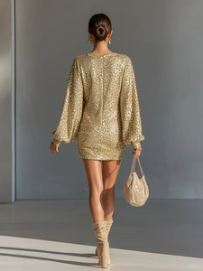 Back view of a gold sequin mini dress with lantern sleeves and a minimalist round neck