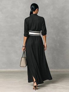 Elegant black long-sleeved dress back view with a striped belt and high side slit