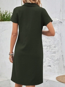 Detail view of the deep green waffle knit texture and polo collar on the short dress