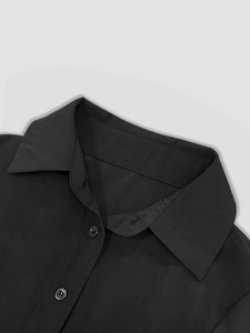 Detailed macro view of a black French vintage maxi dress lapel collar and buttons