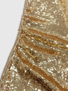 Close-up of golden sequins on a party dress showing detailed metallic texture and shine