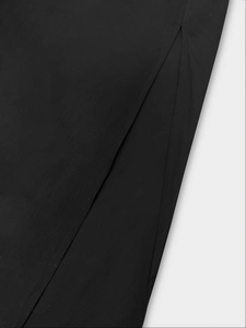 Close-up of the side slit detail on a black vintage dress with premium stitching