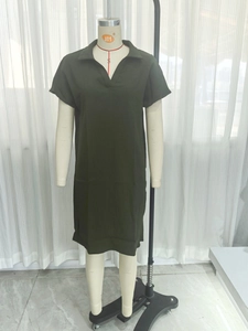 Detailed close-up of dark olive green polo dress with V-neckline and collar design