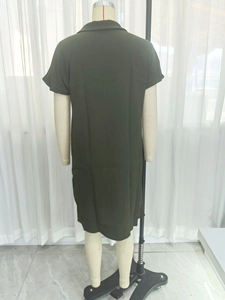 Back view of the dark green short-sleeved dress with a minimalist straight-cut silhouette