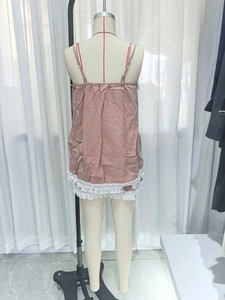 Detail of dusty pink camisole featuring delicate white lace fringe and thin dual straps