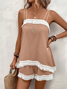 Detailed view of bohemian style set featuring white fringe lace trim on beach outfit