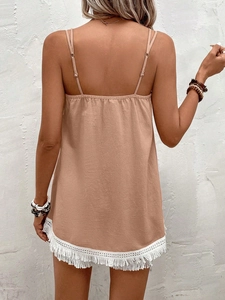 Detailed close-up of beige summer camisole with white lace fringe and delicate straps