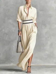 Elegant beige long-sleeve maxi dress with turn-down collar and striped waist detail