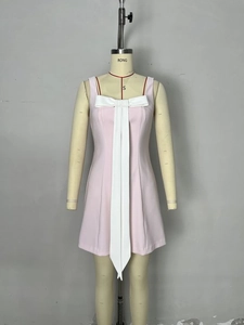 Pink slim fit mini dress with white bow detail and ribbon on mannequin display