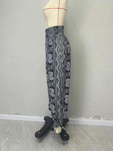 Detail of high waisted bohemian paisley print trousers with elastic ruched waistband