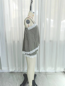 Detail of army green tiered camisole and shorts set with white fringe tassels