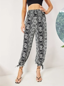Women's high waist bohemian floral print trousers with smocked waist and tie-up split cuffs