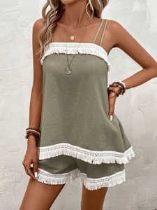 Detail of olive green beach set with white fringe lace on camisole hem and shorts