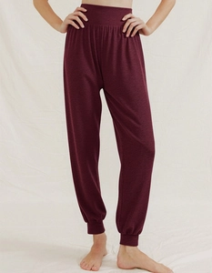 Close-up of high-waist drawstring burgundy yoga pants with elasticated ankle cuffs