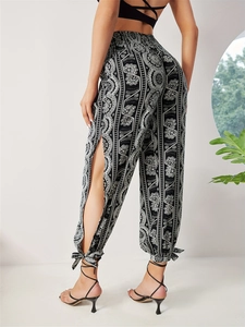 Women's high waist boho print trousers with side slits and tie ankles in black and white